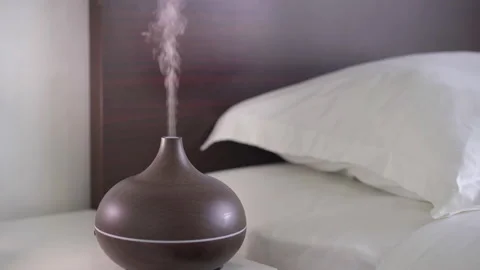 An aromatherapy diffuser working on a nightstand. Deep and restful sleep concept Stock Footage 149250860