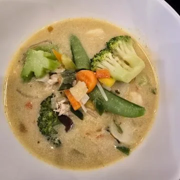 Aromatic and Delicious Vegetable Coconut Soup enriched with chicken for a Stock Photos
