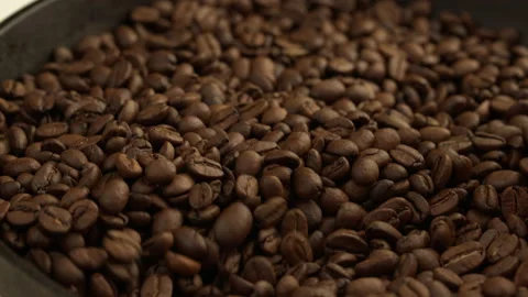 Aromatic and roasted coffee beans on the roaster. Mix the aromatic coffee Video stock 136664213