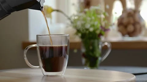 Aromatic black coffee is poured into clear glass cup, Geyser coffee maker, Slow Video stock 172140055