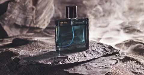 Aromatic blue perfume on dark volcanic rock. Stock Footage 331789014