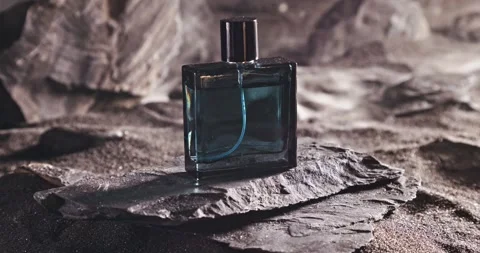 Aromatic blue perfume on dark volcanic rock. 動画素材 332622030