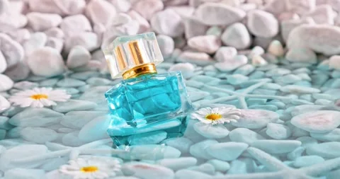 Aromatic blue perfume in environment of white stones and sea. Stock-Footage 335108656