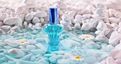 Aromatic blue perfume in environment of white stones and sea. Stock-Footage 338311004