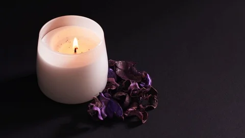 Aromatic candle blown out, dry flowers with a pleasant smell for relaxation in Stock Footage 125277768