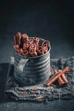 Aromatic cinnamon sticks on dark rustic table Stock Photos