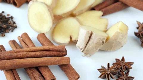 Aromatic cinnamon sticks, fresh ginger root, star anise and cloves . Stock Footage 328500057