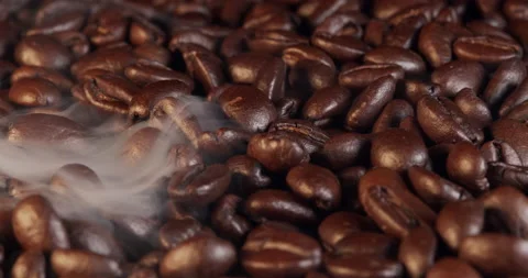 Aromatic coffee beans are roasted in frying pan,smoke comes from coffee beans Stock Footage 236101615
