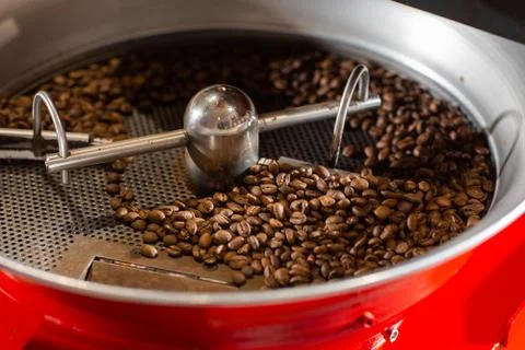 Aromatic coffee beans situating in modern equipment with grain chiller. Industry Stock Photos