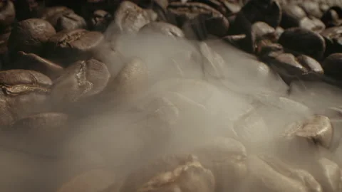 Aromatic coffee beans - soft diffused smoke coming from roasted coffee beans Stock Footage 233602364