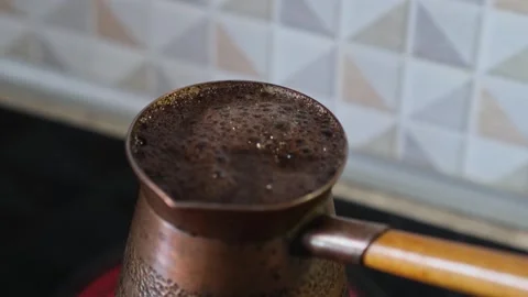 Aromatic coffee boils with foam and bubbles in the turk, close-up. Video stock 271715076