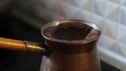 Aromatic coffee boils with foam and bubbles in the turk, close-up. 動画素材 273958799
