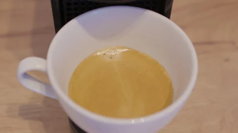 Aromatic coffee brewing drop falls machine into cup close-up slow mo. Aromatic Stock Footage 264726424