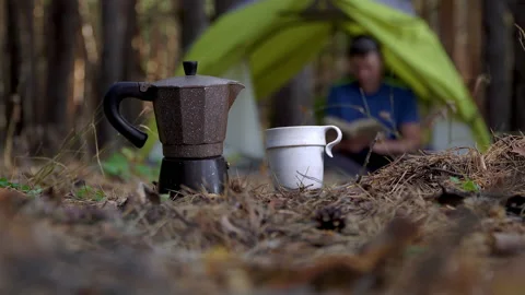 Aromatic coffee in a geyser coffee maker in forest Stock Footage 140603742