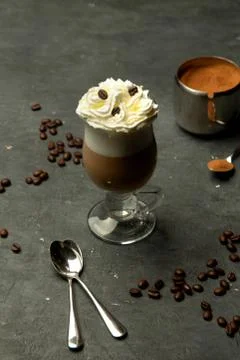 Aromatic coffee in a glass cup with whipped cream Stock Photos