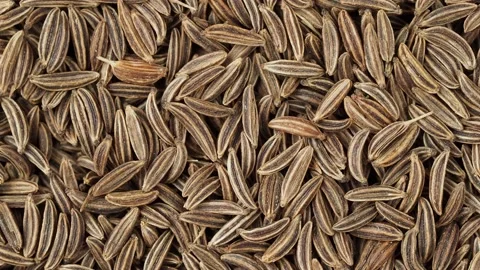 Aromatic cumin dry seeds texture Stock Footage 234524760