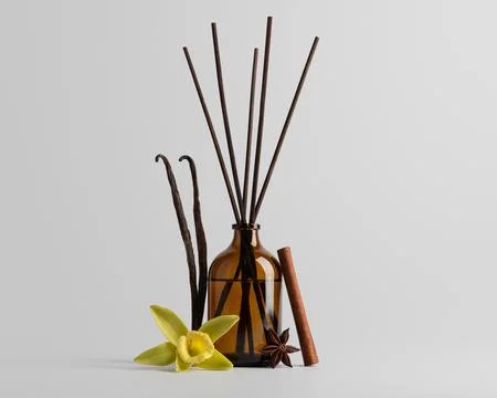 Aromatic diffuser with vanilla, cinnamon, and star anise near brown glass bot Stock Photos