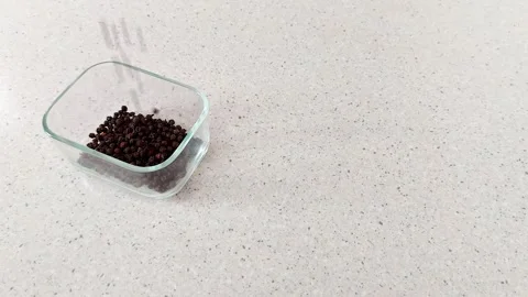 Aromatic Flow: Peppercorns Dropping into Clear Containment 스톡 동영상 315845065