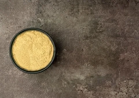 Aromatic Ginger powder from a flat lay angle with a dramatic dark background. Stock Photos
