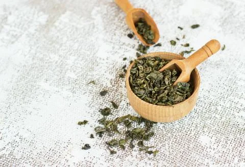 Aromatic green dry tea on light coloured white Stock Photos