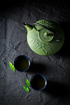 Aromatic green tea on black table. Chinese cuisine. Stock Photos