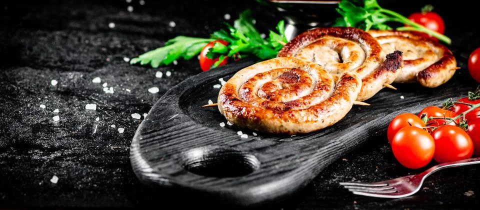 Aromatic grilled sausages with a ruddy crust. Stock Photos