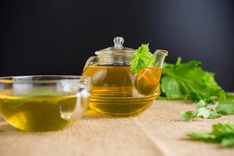 Aromatic herbal tea from mint and currant on a black background Stock Photos