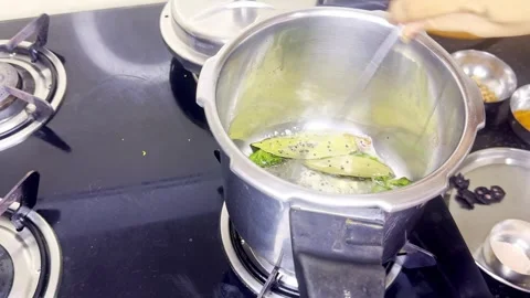 Aromatic Herbs Simmering in Kitchen Pressure Cooker Stock Footage 312036203