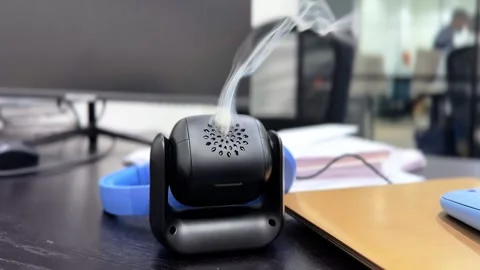 Aromatic Incense Diffuser Releasing Smoke on Office Desk – 4K Footage. Video stock 309614810
