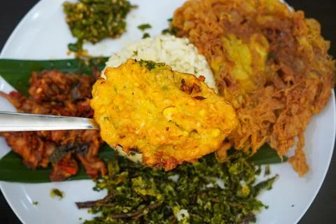 Aromatic lime leaf rice served with spicy stir-fried chicken skin Stock Photos