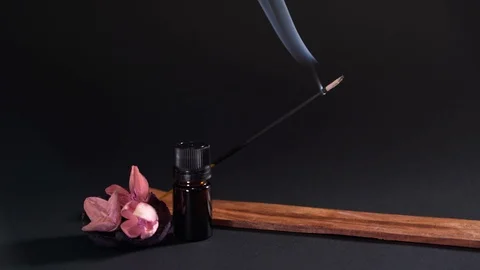 Aromatic objects are isolated on a black background. Incense, aromatic oil and Stock Footage 124859276