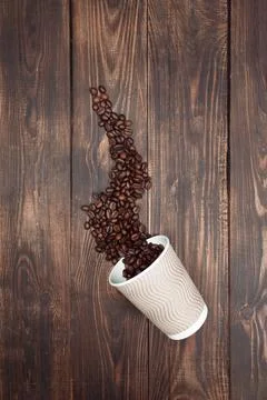 Aromatic roasted coffee beans with take-out mock-up paper cup. dark backgro.. Stock Photos