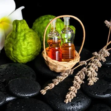 Aromatic spa concept of bottles essential oil, bergamot fruits, plumeria flow Foto stock