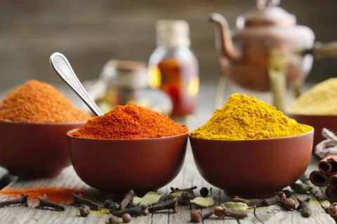 Aromatic spices: red chilli pepper, turmeric, curcuma, cardamom, cinnamon Stock Photos