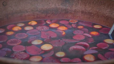 Aromatic steaming hot spiced alcoholic mulled fruity wine drink Stock Footage 303486545