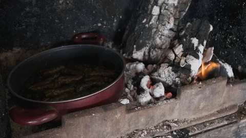 Around stuffed grape leaves in a pan on wood fire Stock Footage 122695884