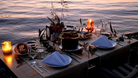Around a traditional Turkish dinner table in the sea at beach Stock Footage 113764028