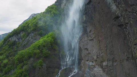 Arpenaz Waterfall - Lateral Flight with Cliff and Forest - 4K Stock Footage 276103179