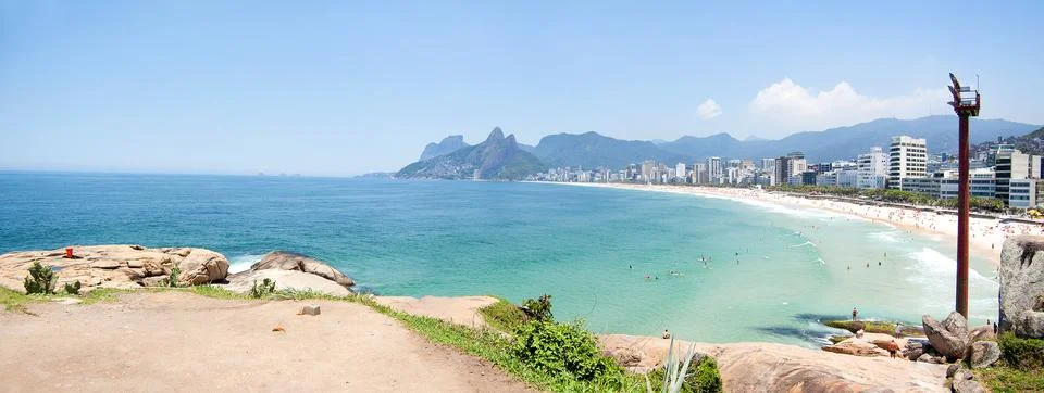 Arpoador stone view in rio de janeiro brazil during summer. Blue sky, blue wa Stock Photos