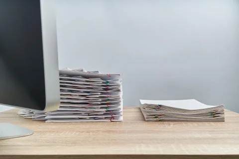 Arrange pile document overload report and computer on wooden table Stock Photos