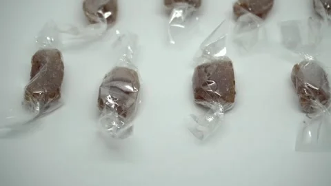 An arranged group of ginger candy wrapped in plastic Stock Footage 296895086