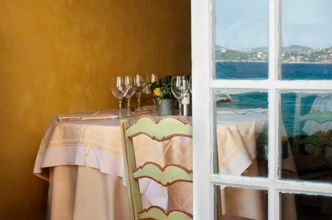 Arranged table in a restaurant and open window Stock Photos