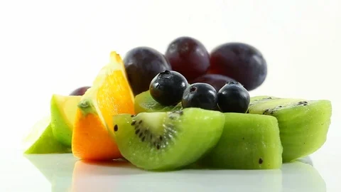 An arrangement of 5 different fruit items slowly rotating on a white surface Stock Footage 87857270