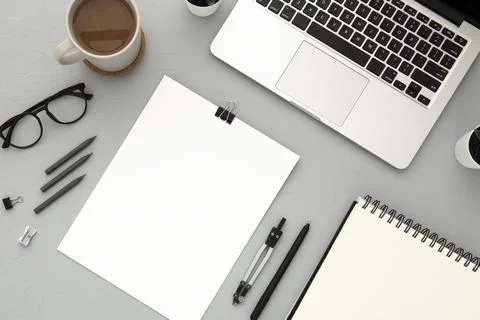 Arrangement desk elements with empty notebook grey background Stock Photos
