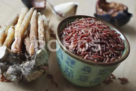 An arrangement of fingerroot and a bowl of red rice (Thailand) Stock Photos
