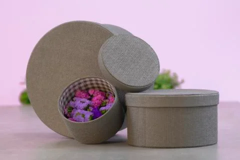 Arrangement of gray round boxes of different sizes with flowers Stock Photos