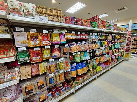 Arrangement of various types of nuts in plastic packs in a supermarket Stock Photos