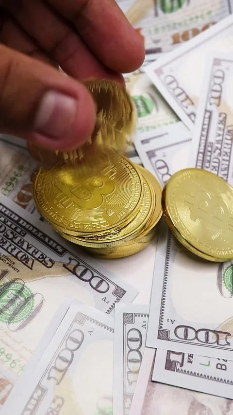 Arranging Bitcoin Stack on Cash Background. Stock Footage 289434773