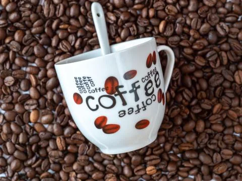Arranging coffee beans with a mug Stock Photos