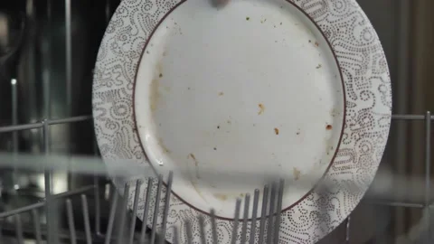 Arranging dirty dishes in the dishwasher machine Stock Footage 169769797